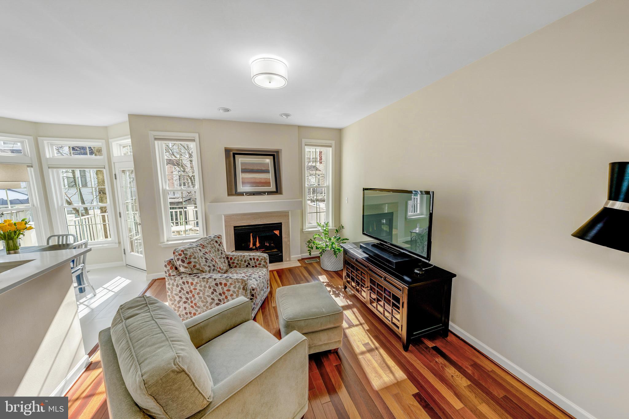 1916 Logan Manor Drive Reston, VA 20190 - Photo 11 of 56 a living room with furniture a flat screen tv and a fireplace