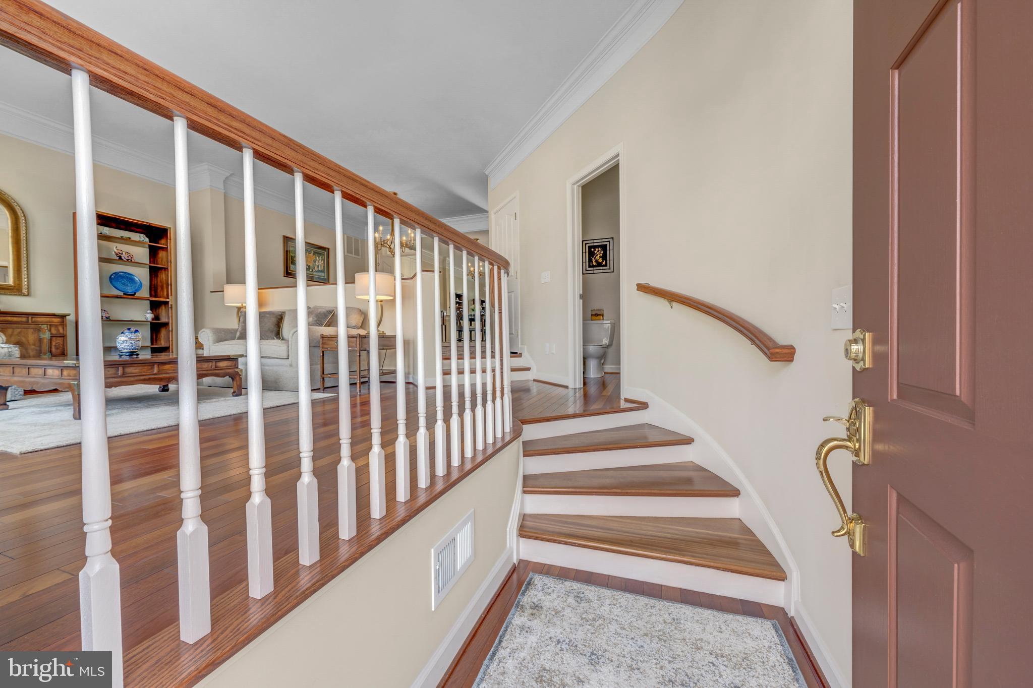 1916 Logan Manor Drive Reston, VA 20190 - Photo 2 of 56 a view of staircase with lots of frames on wall and a window
