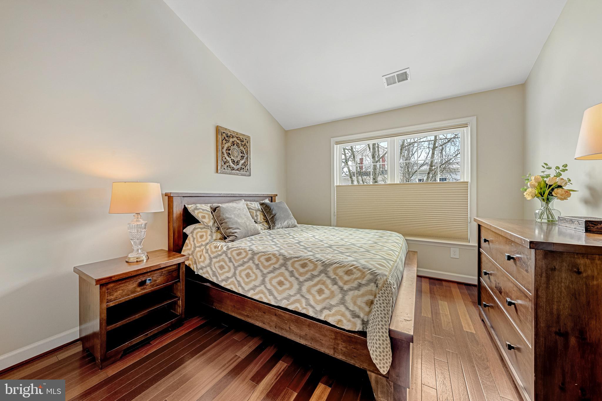 1916 Logan Manor Drive Reston, VA 20190 - Photo 24 of 56 a bedroom with a bed and wooden floor