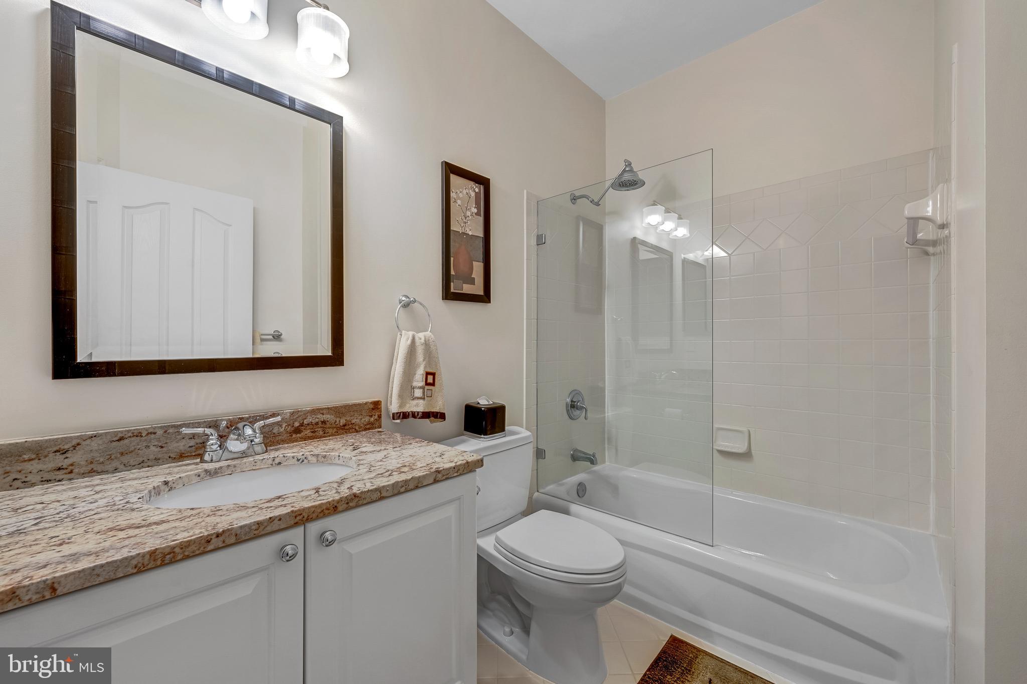 1916 Logan Manor Drive Reston, VA 20190 - Photo 26 of 56 a bathroom with a granite countertop sink a toilet and shower