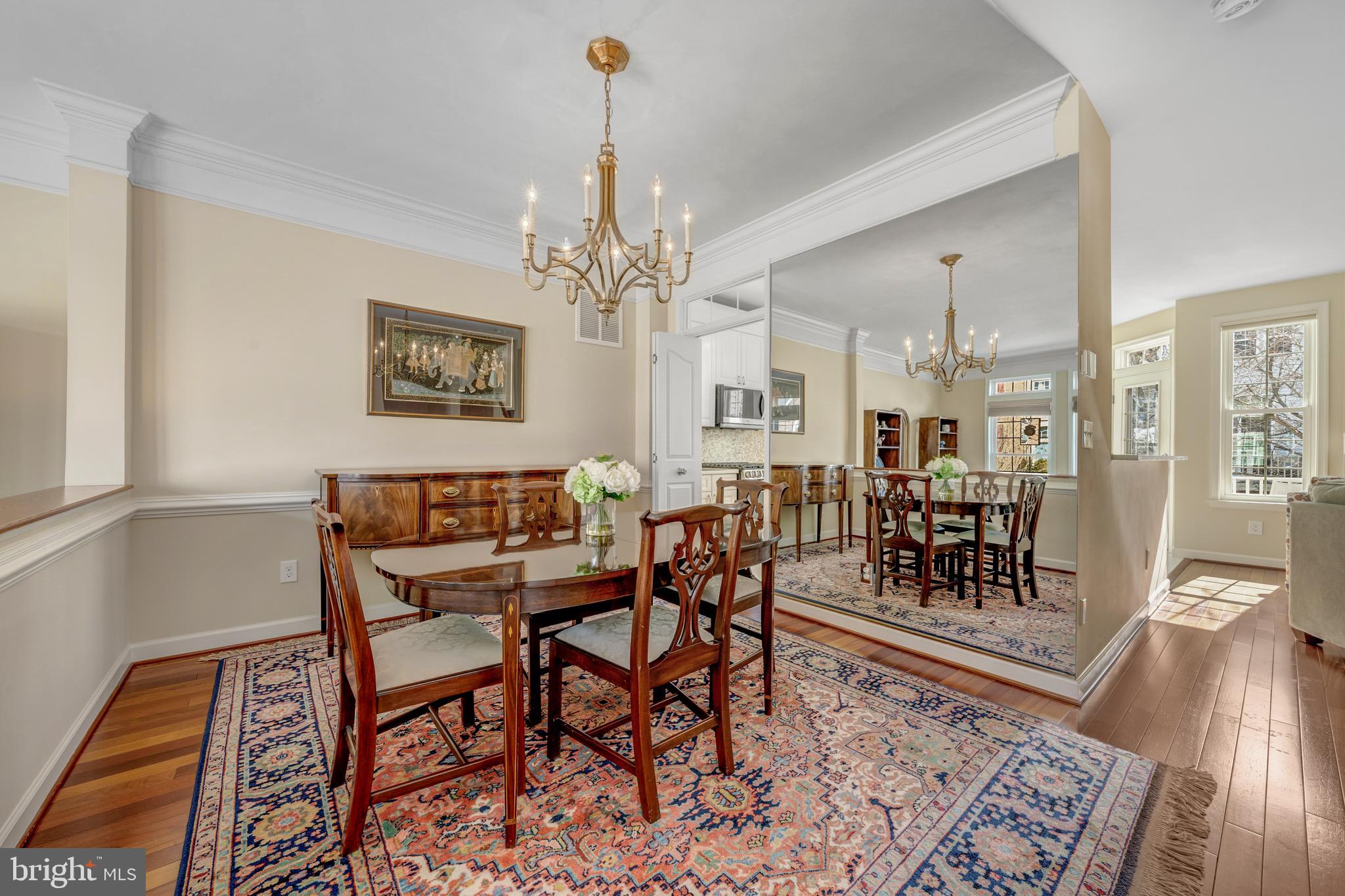 1916 Logan Manor Drive Reston, VA 20190 - Photo 40 of 56 a view of a dining room and livingroom with furniture wooden floor a rug and a chandelier
