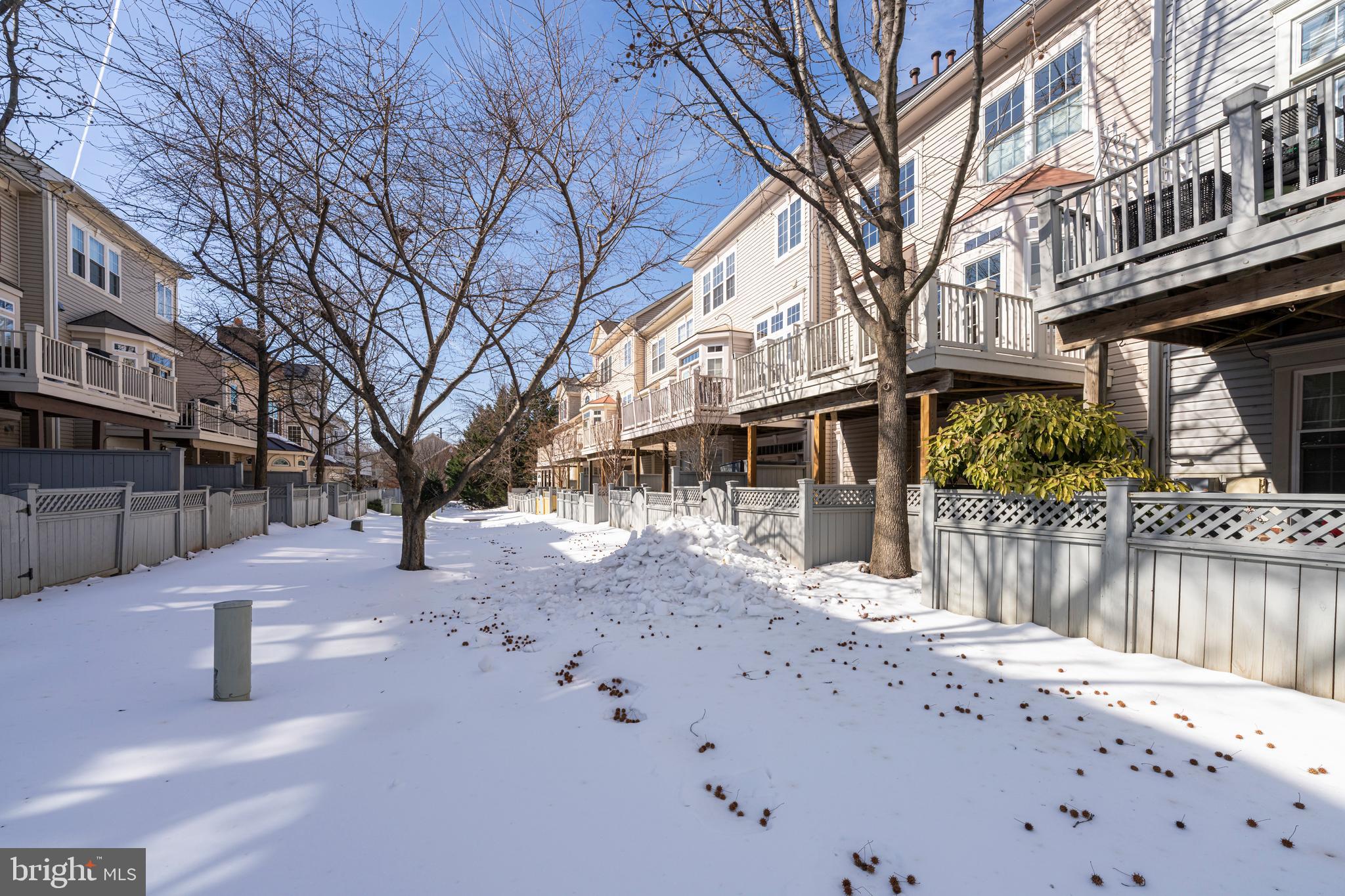1916 Logan Manor Drive Reston, VA 20190 - Photo 47 of 56 a view of a house with a yard covered in snow