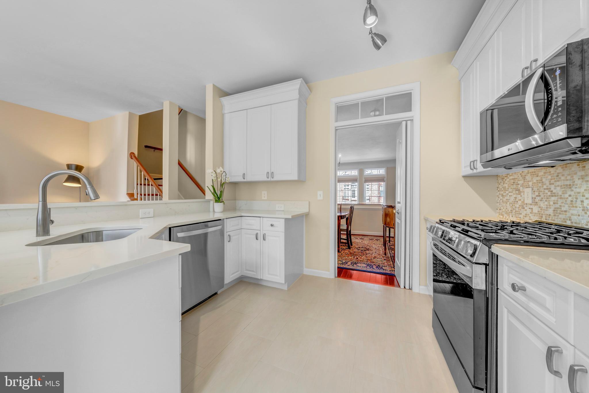 1916 Logan Manor Drive Reston, VA 20190 - Photo 6 of 56 a kitchen with granite countertop a sink stove and cabinets