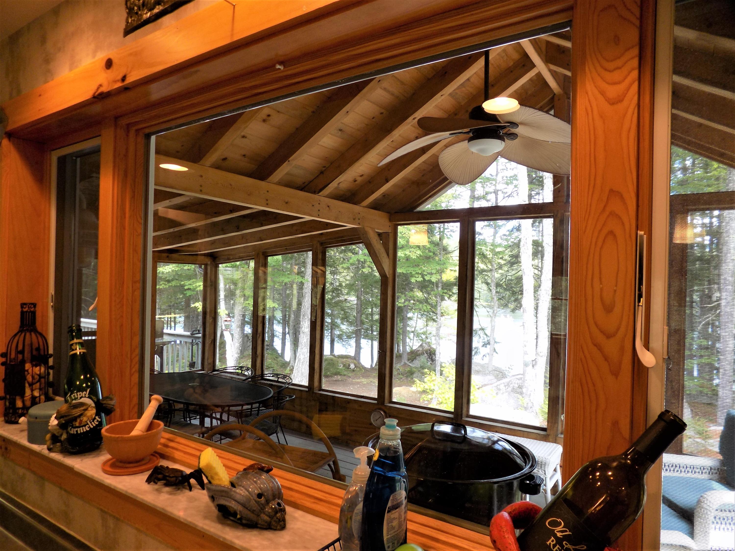 171 Long Point Way Orland, ME 04472 - Photo 10 of 63 Looking onto the screened porch and lake