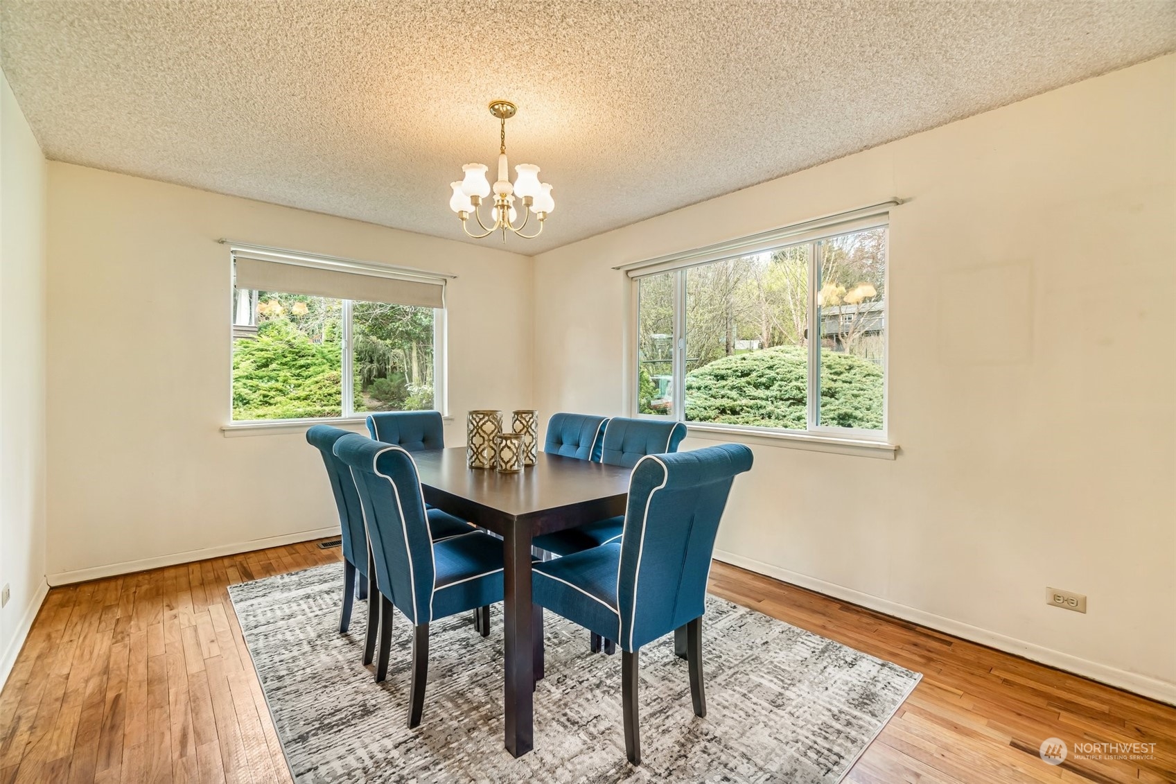 24324 7th Avenue West Bothell, WA 98021 - Photo 11 of 40 a view of a dining room with furniture a chandelier and wooden floor