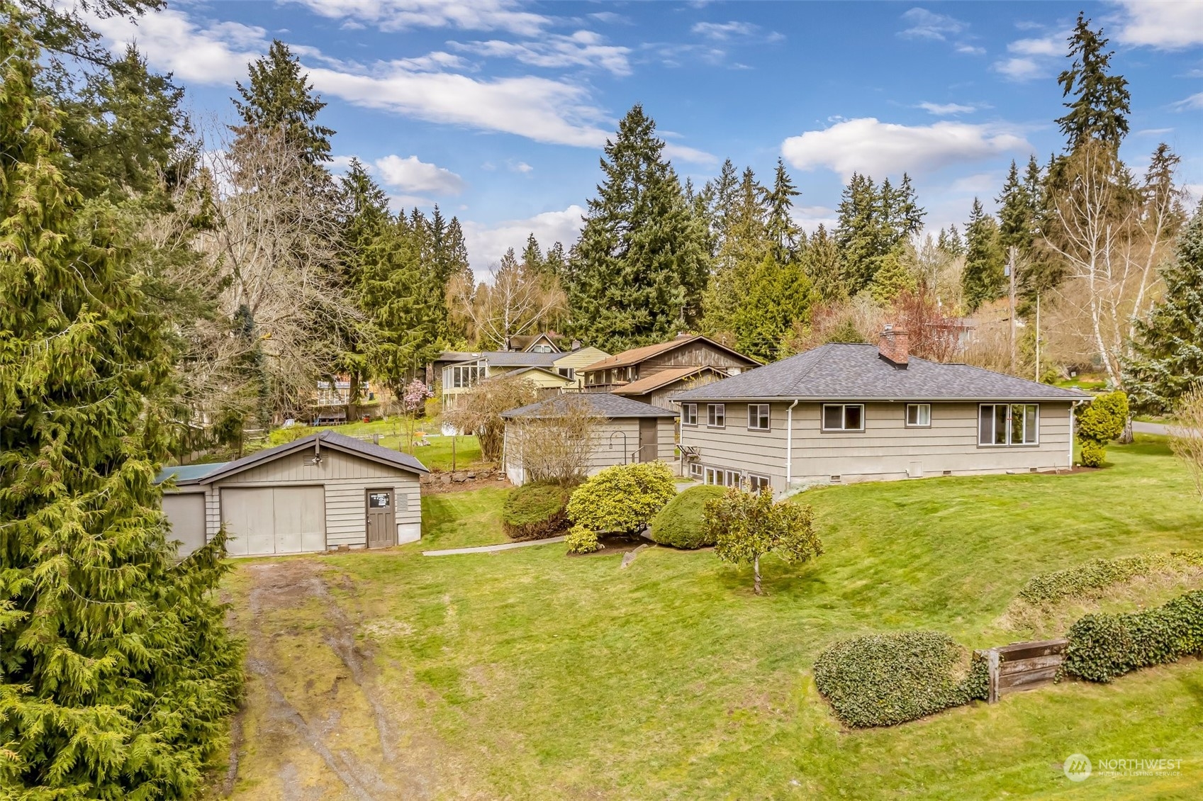 24324 7th Avenue West Bothell, WA 98021 - Photo 36 of 40 a view of a big house with large trees and plants