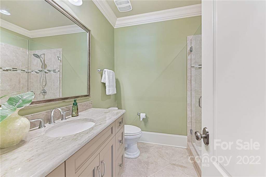 1951 Harris Road Charlotte, NC 28211 - Photo 22 of 35 a bathroom with a granite countertop sink a toilet and a mirror