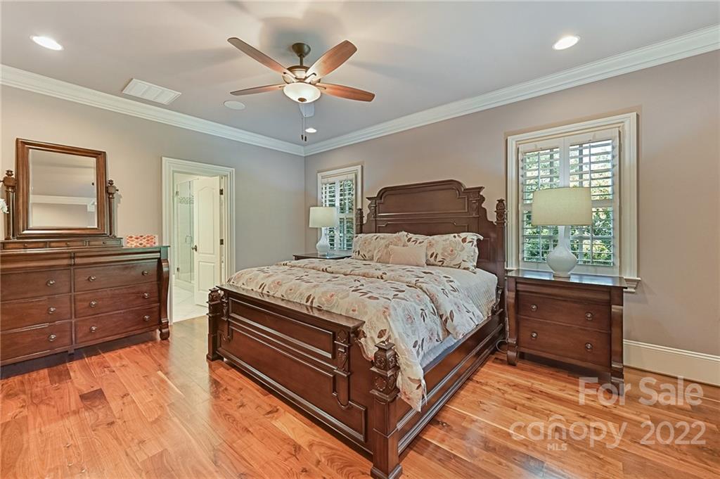 1951 Harris Road Charlotte, NC 28211 - Photo 23 of 35 a bedroom with a large bed and a chandelier
