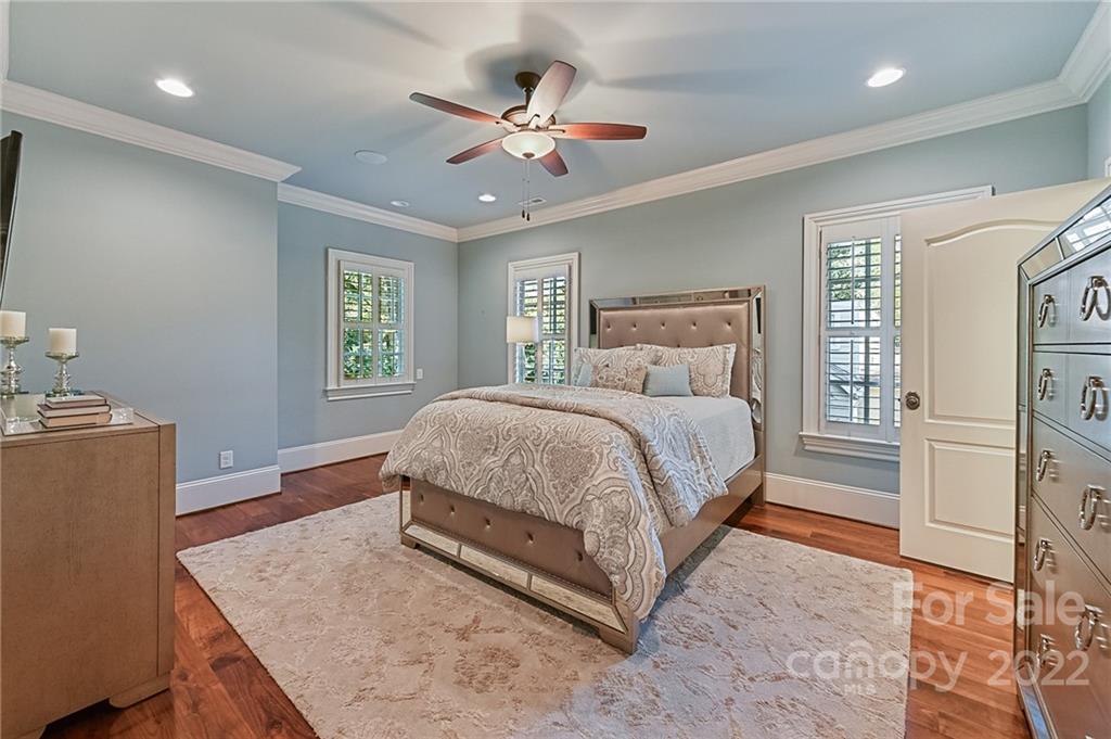 1951 Harris Road Charlotte, NC 28211 - Photo 25 of 35 a bedroom with a large bed and a chandelier