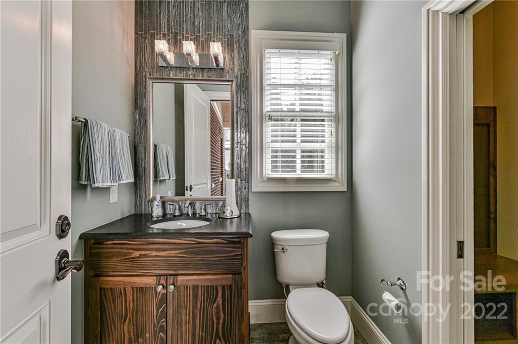 1951 Harris Road Charlotte, NC 28211 - Photo 33 of 35 a bathroom with a toilet a sink and a window