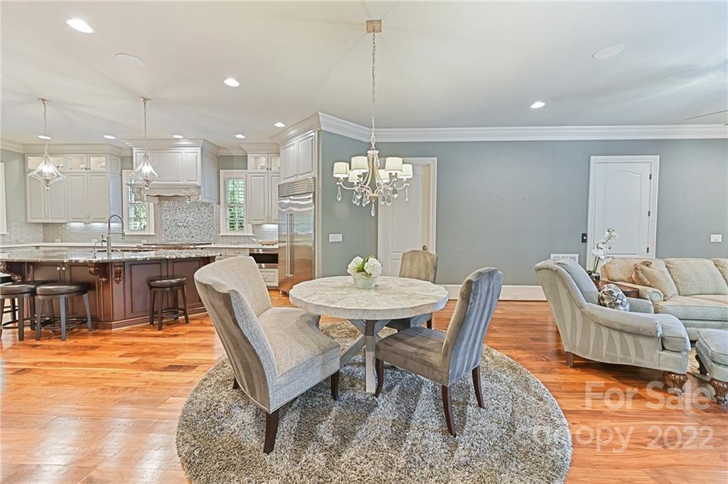 1951 Harris Road Charlotte, NC 28211 - Photo 8 of 35 a dining room with furniture a rug and a chandelier
