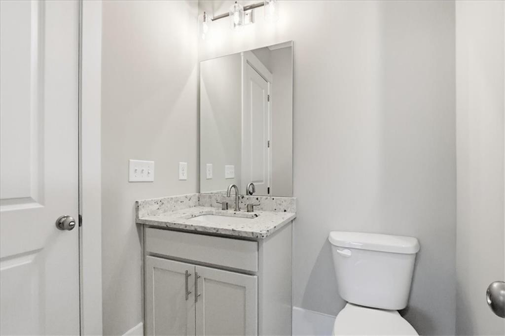 216 Ewing Way Dacula, GA 30019 - Photo 41 of 80 a bathroom with a toilet sink and mirror