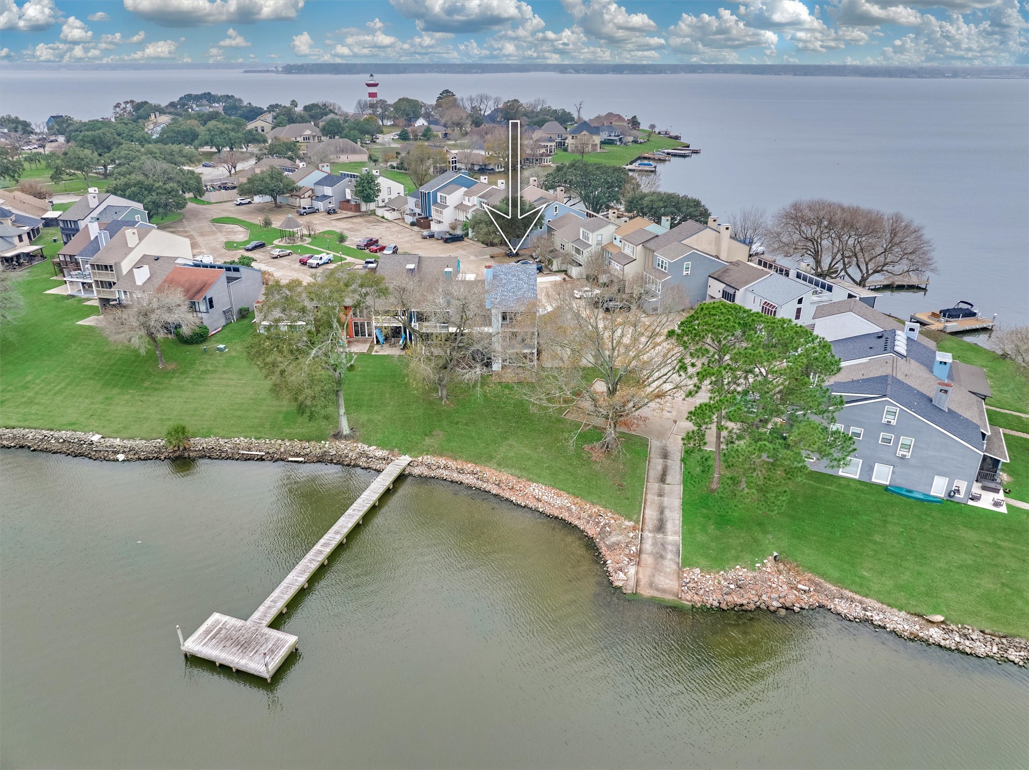 1427 Bowsprit Point Willis, TX 77318 - Photo 4 of 47 This home sits on a quiet street with other lakefront townhomes. Pictured here are the boat ramp to Lake Conroe and dock space just outside of the home.
