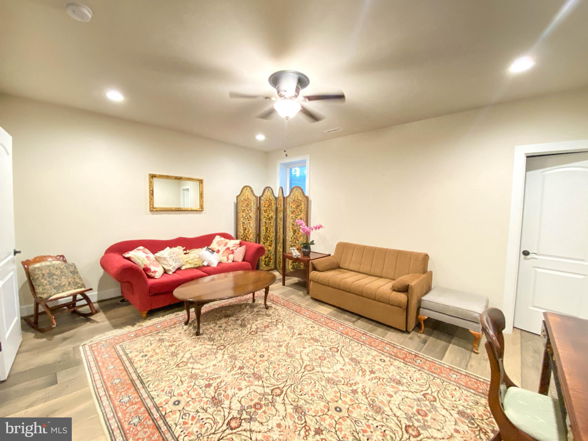 2342 Courthouse Road Stafford, VA 22554 - Photo 48 of 66 a living room with furniture a rug and a chandelier
