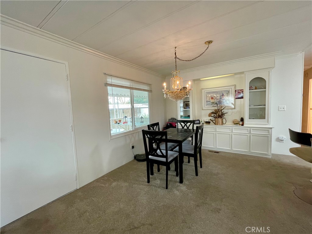 31130 South General Kearny Road, Unit 145 Temecula, CA 92591 - Photo 9 of 27 a view of a dining room with furniture and chandelier