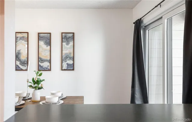 a view of a hallway with wooden floor and a potted plant