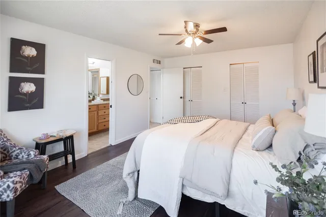 a bedroom with a bed a table and chair