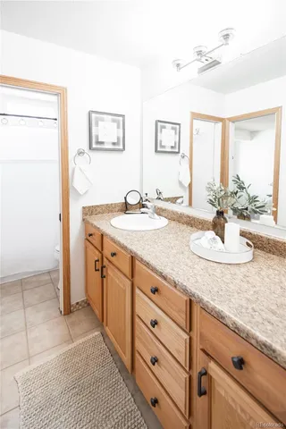 a bathroom with a granite countertop sink and a mirror