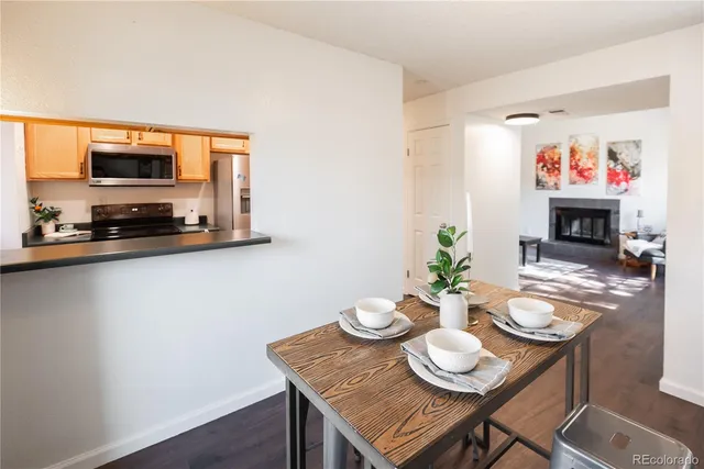 a view of a dining room with furniture and a flat screen tv