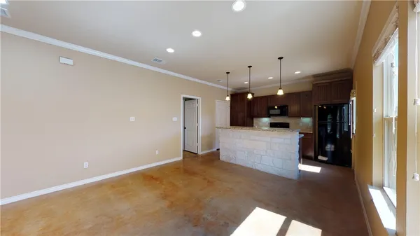 a open kitchen with white cabinets and stainless steel appliances