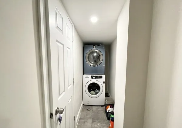 a bathroom with a sink a toilet a mirror and shower