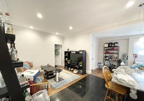 a living room with furniture and a flat screen tv