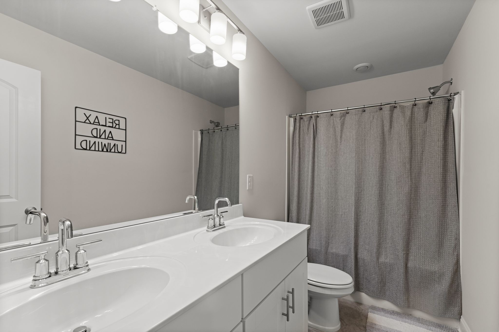 2004 Notchleaf Road Antioch, TN 37013 - Photo 17 of 19 a bathroom with a double vanity sink toilet and a mirror