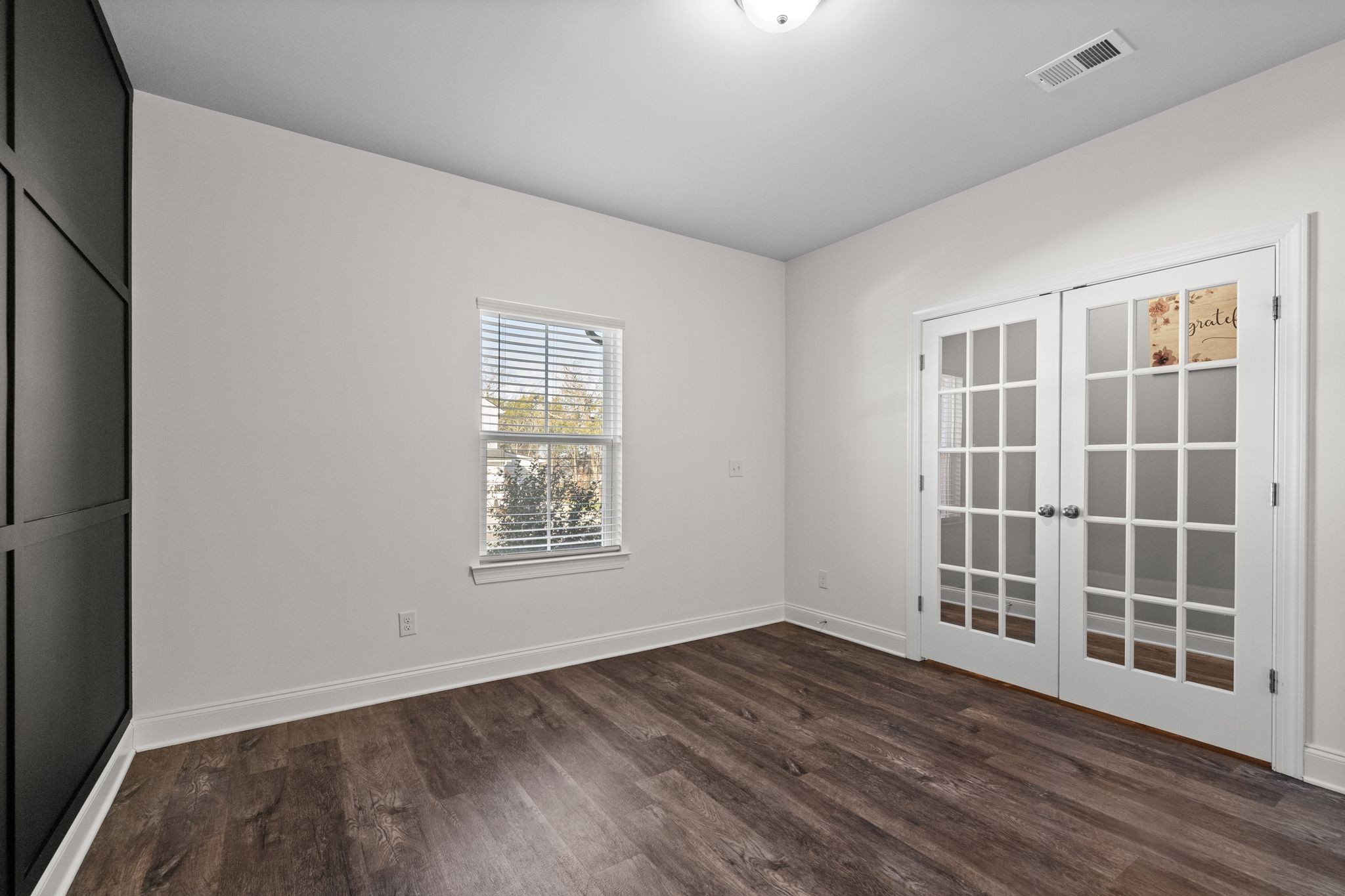 2004 Notchleaf Road Antioch, TN 37013 - Photo 4 of 19 an empty room with wooden floor and windows