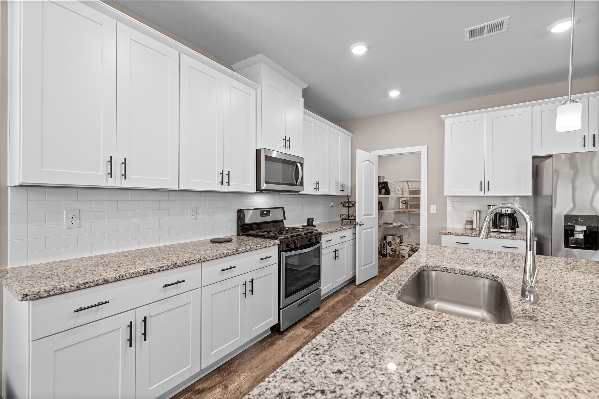 2004 Notchleaf Road Antioch, TN 37013 - Photo 8 of 19 a kitchen with granite countertop white cabinets stainless steel appliances and a sink