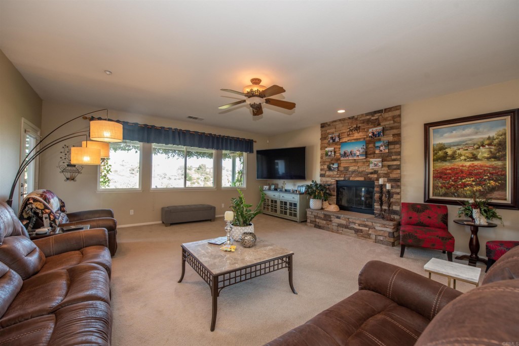 28288 Deep Canyon Drive Escondido, CA 92026 - Photo 13 of 75 a living room with furniture a flat screen tv and a large window