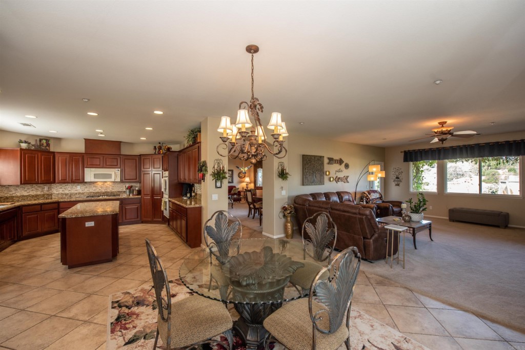 28288 Deep Canyon Drive Escondido, CA 92026 - Photo 14 of 75 a living room with lots of furniture and a chandelier