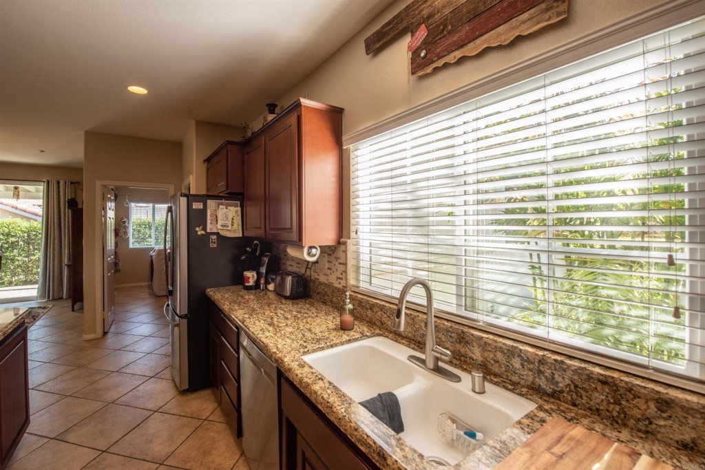 28288 Deep Canyon Drive Escondido, CA 92026 - Photo 19 of 75 a bathroom with a granite countertop sink and a large mirror