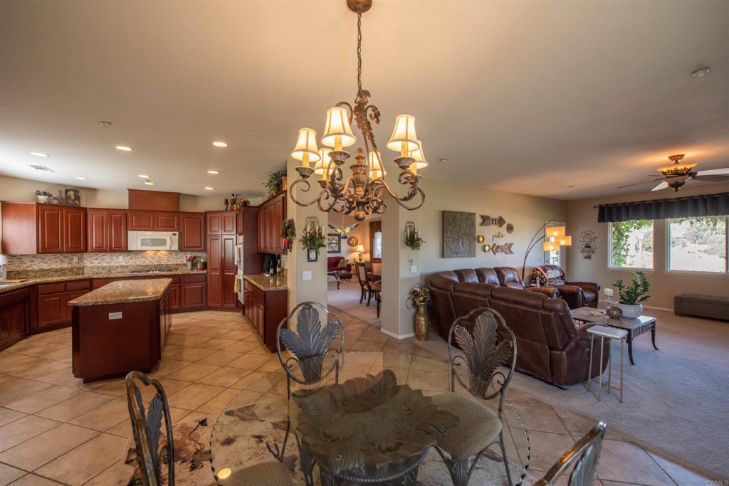 28288 Deep Canyon Drive Escondido, CA 92026 - Photo 26 of 75 a living room with fireplace furniture and a chandelier