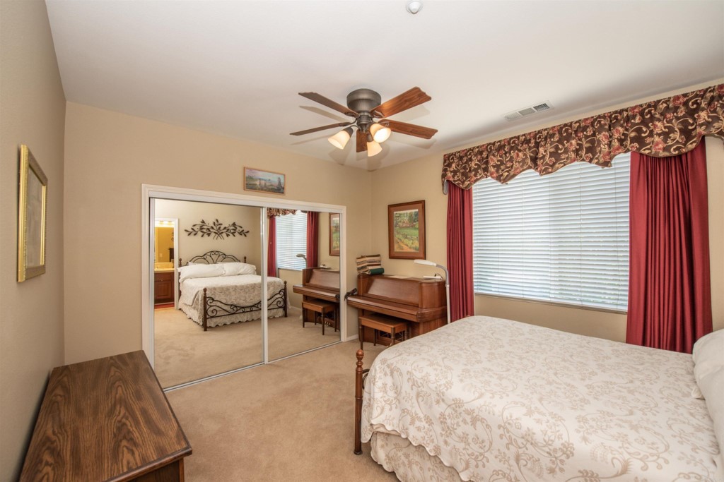 28288 Deep Canyon Drive Escondido, CA 92026 - Photo 47 of 75 a bedroom with a bed and a chandelier