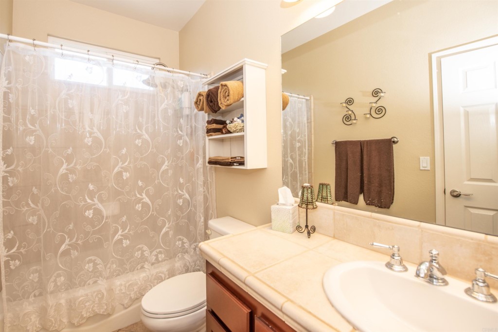 28288 Deep Canyon Drive Escondido, CA 92026 - Photo 51 of 75 a bathroom with a sink toilet and shower
