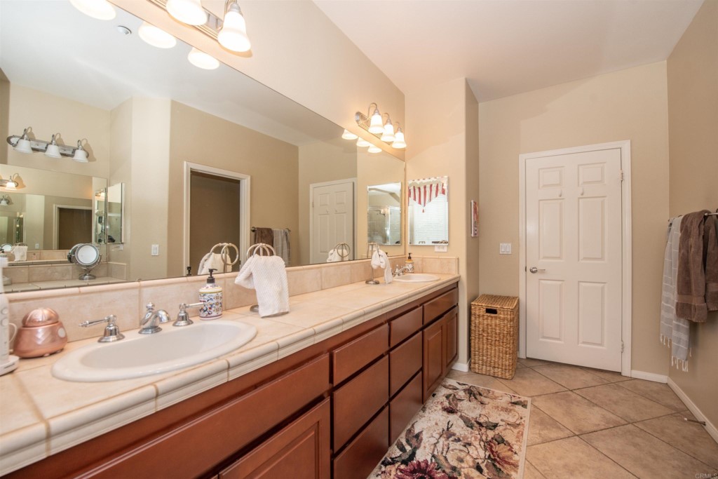 28288 Deep Canyon Drive Escondido, CA 92026 - Photo 60 of 75 a bathroom with a sink double vanity and a mirror