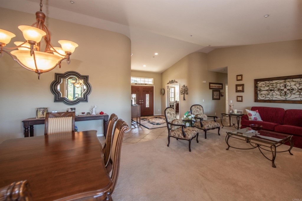 28288 Deep Canyon Drive Escondido, CA 92026 - Photo 65 of 75 a living room with furniture a chandelier and a dining table