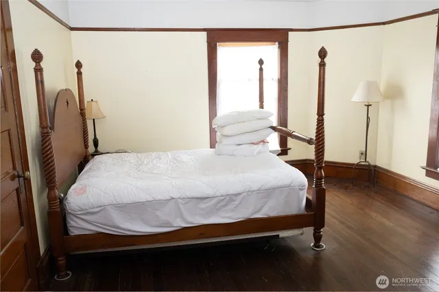 a bed sitting in a bedroom next to a window