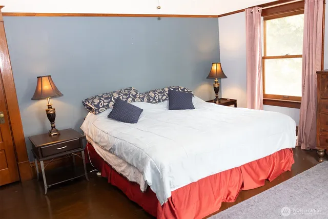 a bedroom with a bed and a lamp