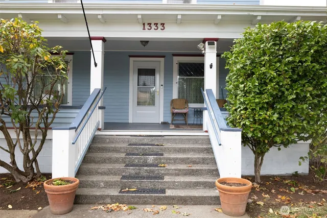 a front view of a house with potted plants