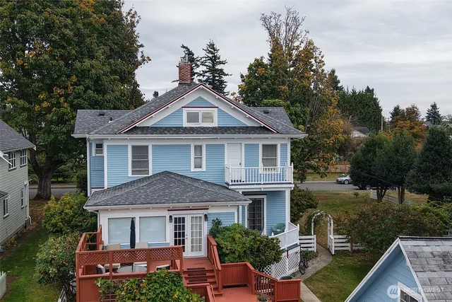 a bedroom with wooden floor and a bed