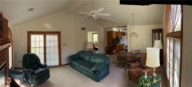 a living room with furniture a fireplace and a chandelier