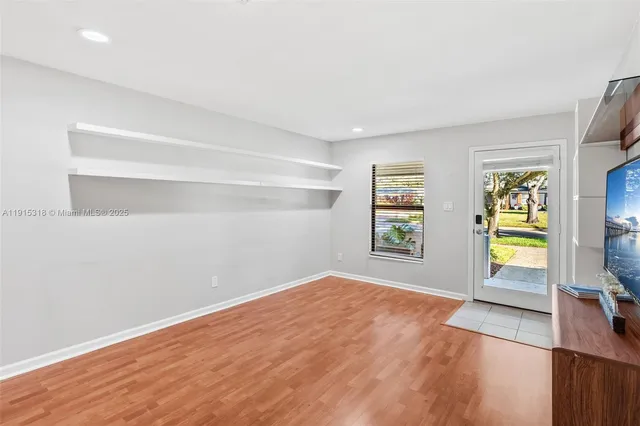 a view of a room with window and wooden floor