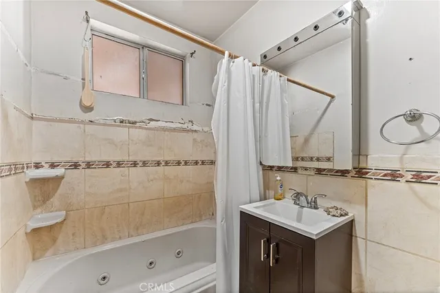 a bathroom with a sink a mirror and a shower
