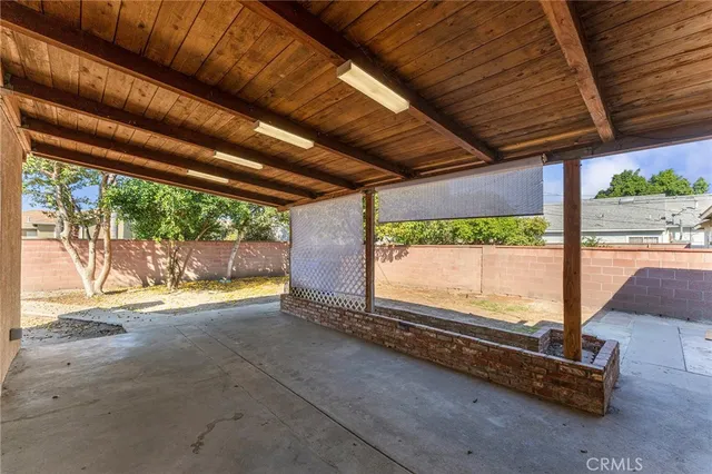 a view of a room with wooden floor and roof with a big yard