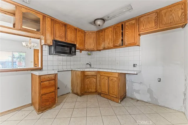 a kitchen with stainless steel appliances granite countertop a sink and cabinets