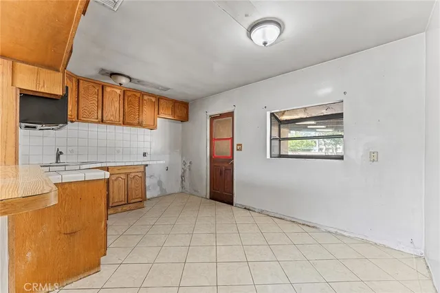 a view of a kitchen with electric appliances