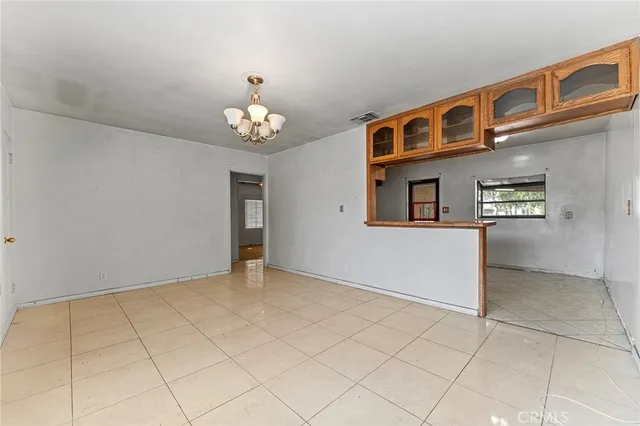 a view of an empty room with chandelier