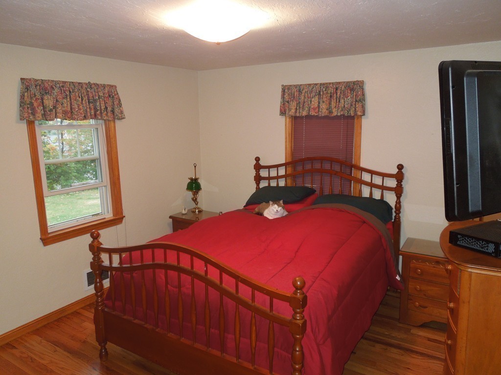 9 Meadowbrook Road Hudson, MA 01749 - Photo 11 of 18 a bedroom with a bed and wooden floor