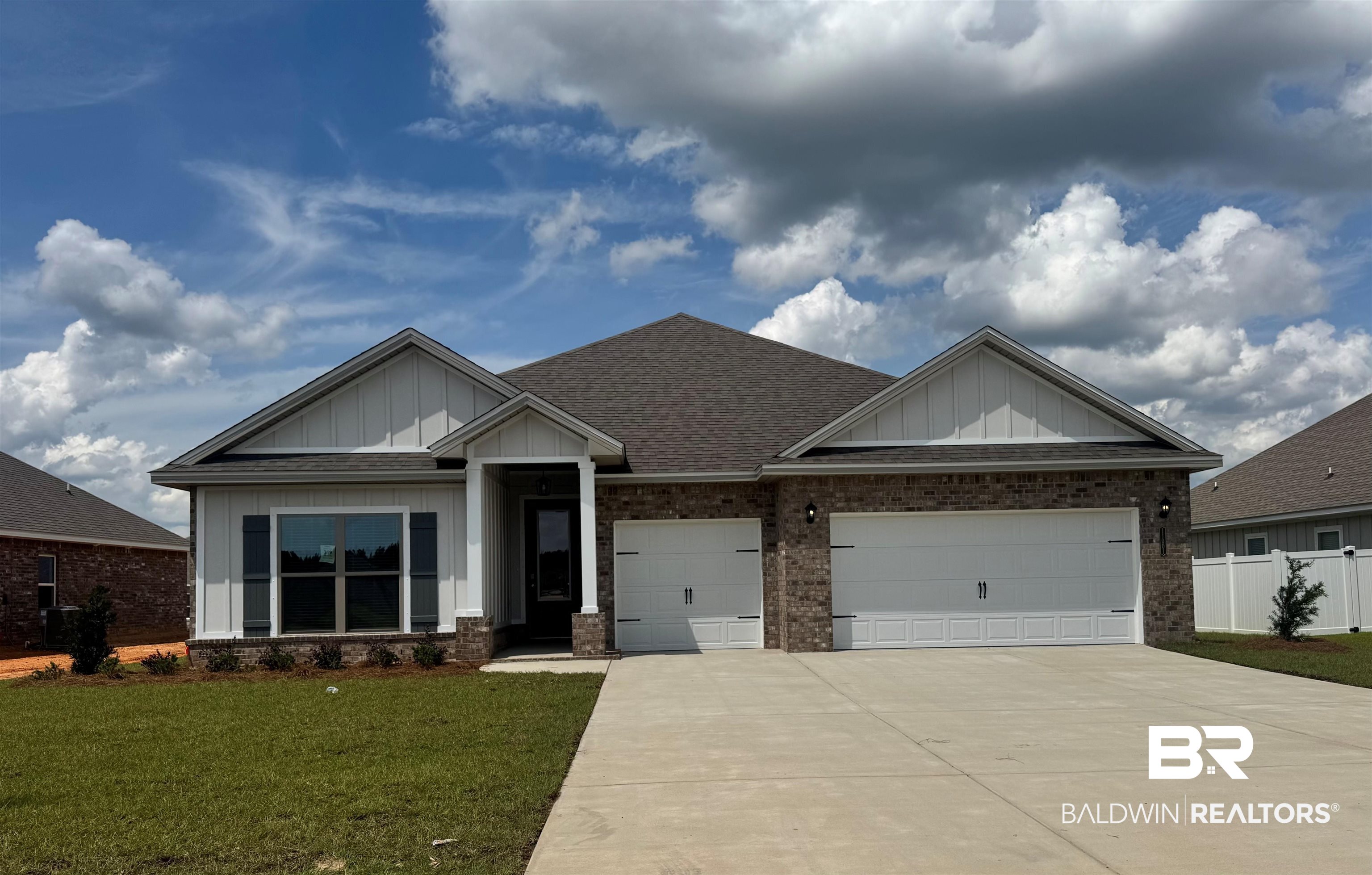 11001 Secretariat Boulevard Daphne, AL 36526 - Photo 1 of 39 Craftsman house featuring board and batten siding, driveway, a garage, a shingled roof, and brick siding